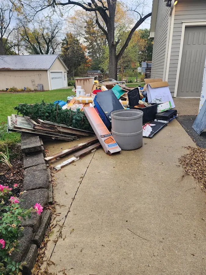 Dumpster being loaded with debris for 12 Yard Dumpster Rental in Pulaski